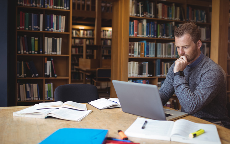 students taking an exam in a classroom focused on writing with pencils preparing for assessments in an educational setting