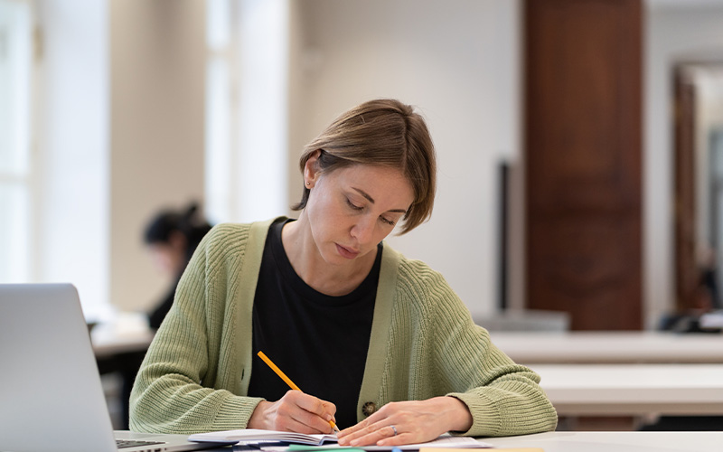 person sitting at a desk with books studying 7 skills for success